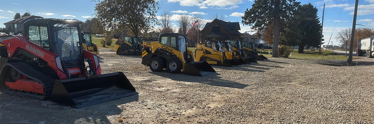 Side angle of Farm Equipment parked on gravel road in front of houses